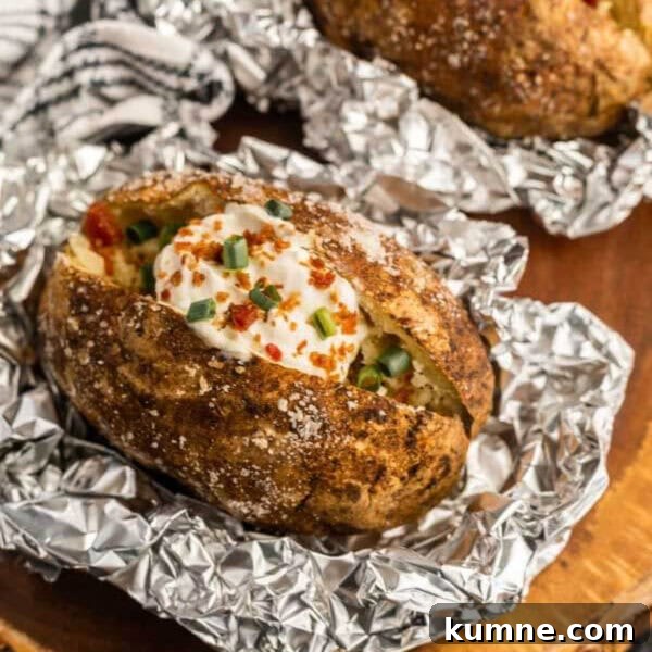 Crispy Foil-Grilled Potatoes with Garlic and Herbs 7 Baked potatoes with cheese and toppings on foil.