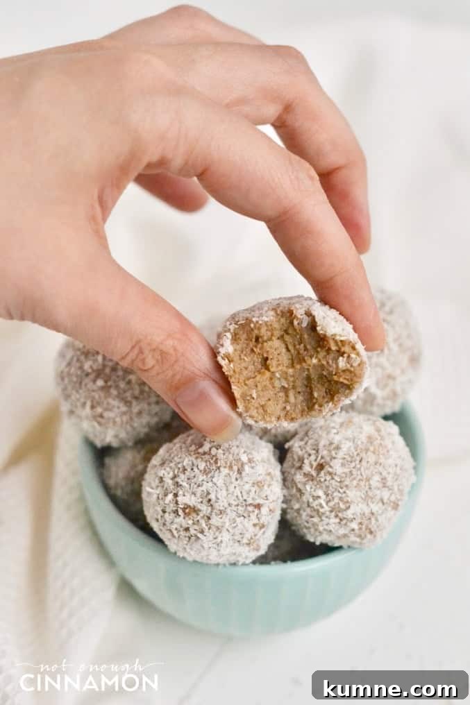 Banana Bread Energy Bites — Vegan, Gluten-Free, Paleo + Video 4 a hand holding half a paleo banana bread energy bite over a bowl of more energy bites