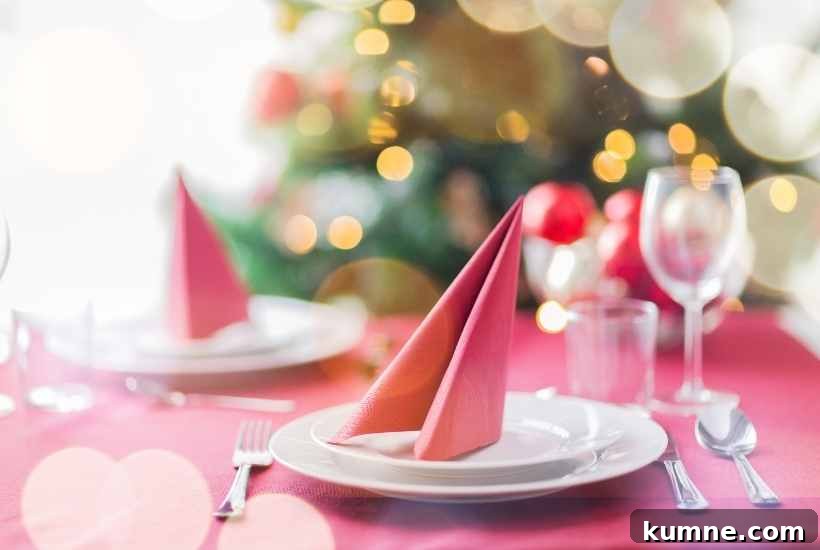 A table decorated for Christmas tea with Christmas tree in the background.