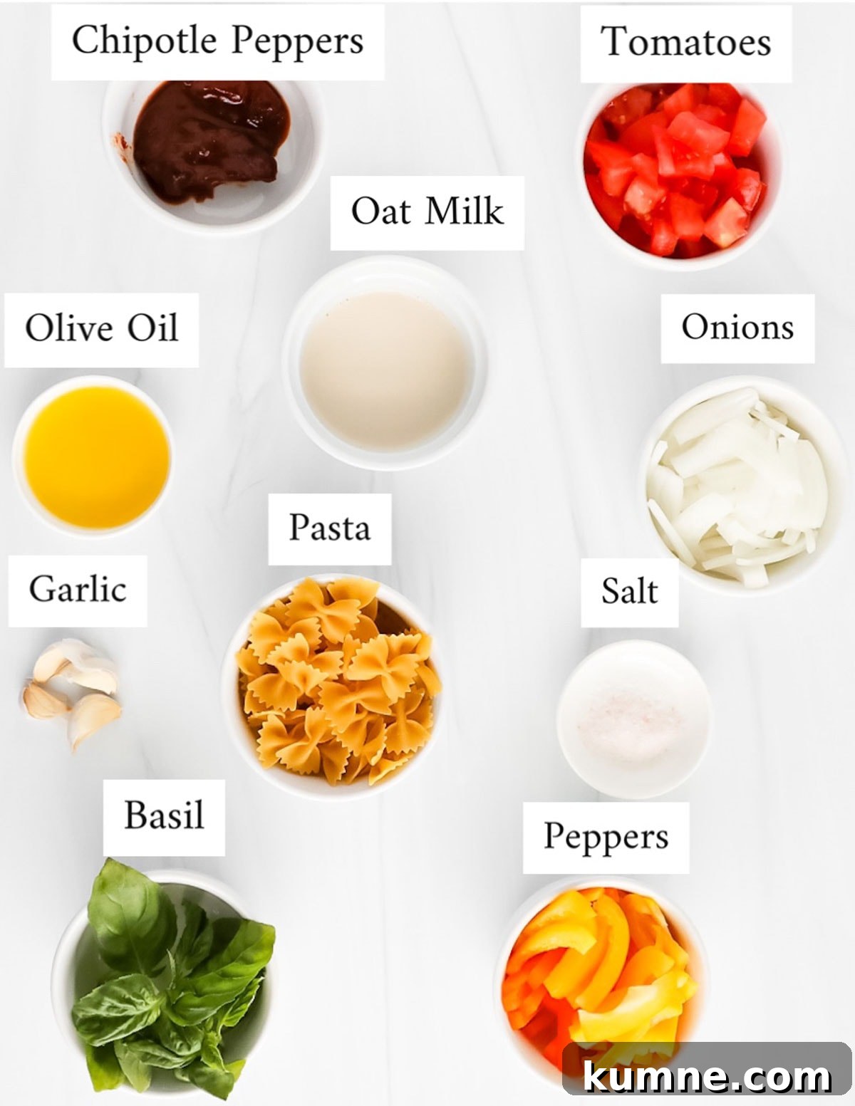 Labeled ingredients in small white bowls including chipotle peppers, tomatoes, oat milk, olive oil, onions, pasta, garlic, salt, basil, peppers.