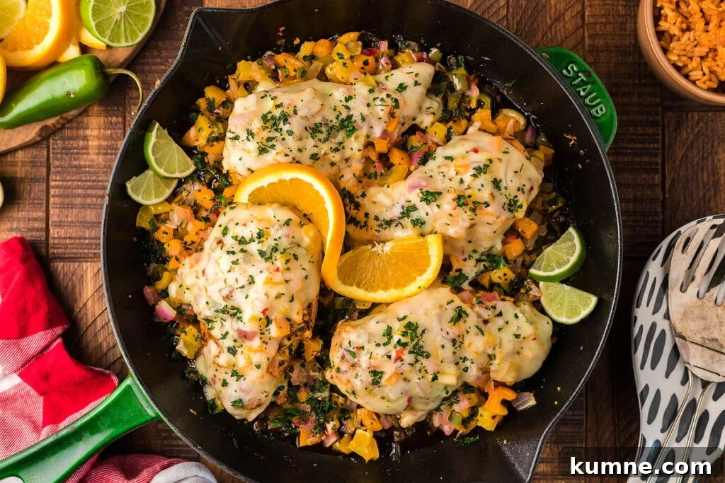 A chicken dish in a green cast iron skillet.