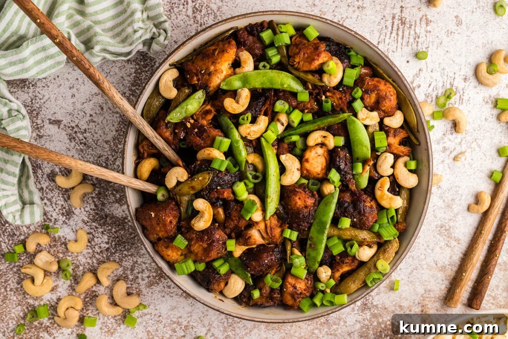 Cashew chicken served in a white bowl.