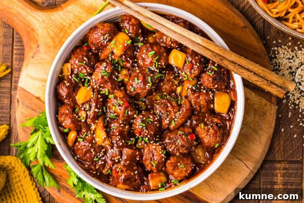 A large white bowl full of chicken manchurian.