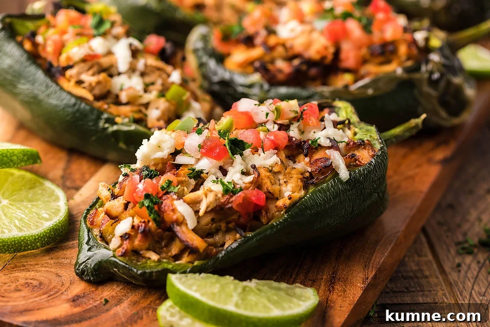 Stuffed poblano peppers on a cutting board.