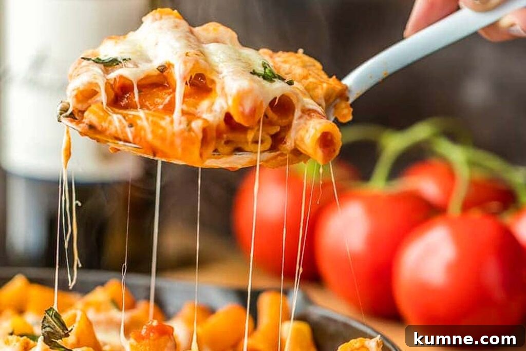 Scooping a dish of chicken pasta.