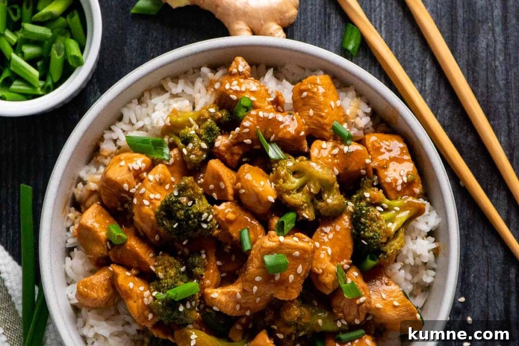 Chicken and broccoli in a serving bowl with rice.