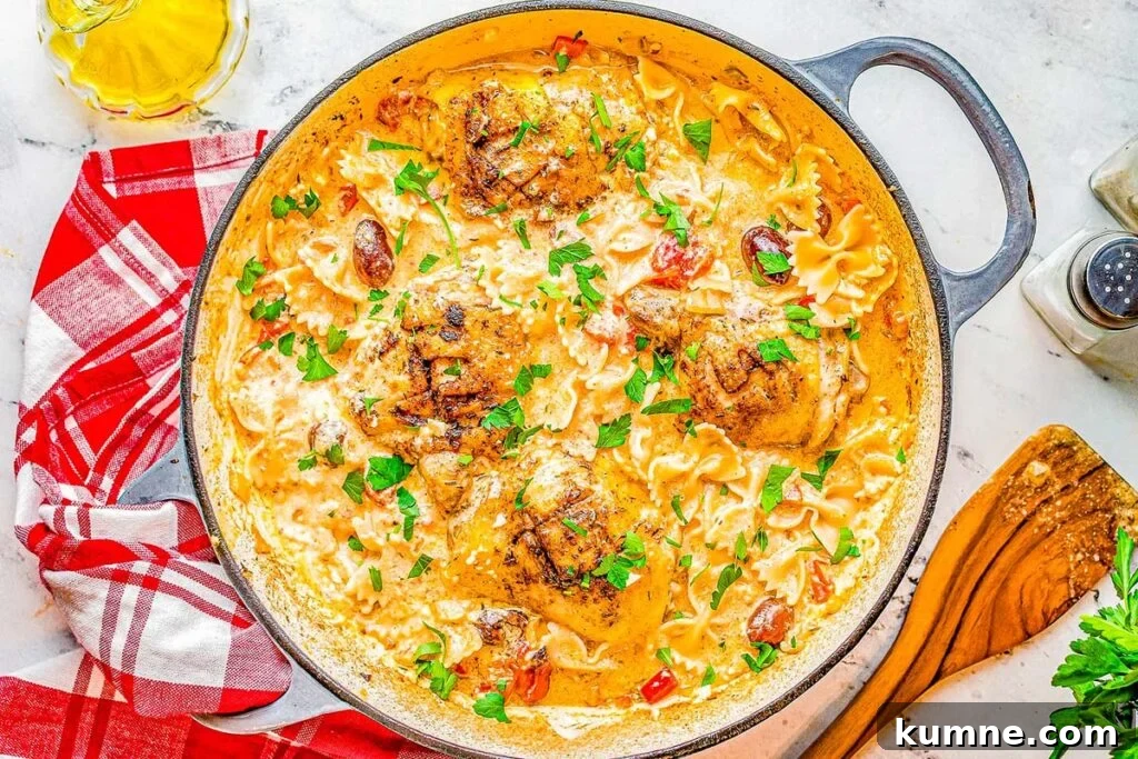 A skillet with baked chicken and pasta.