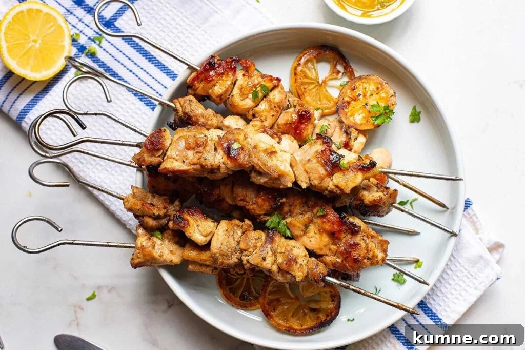 Lemon greek chicken kabobs on a white plate.