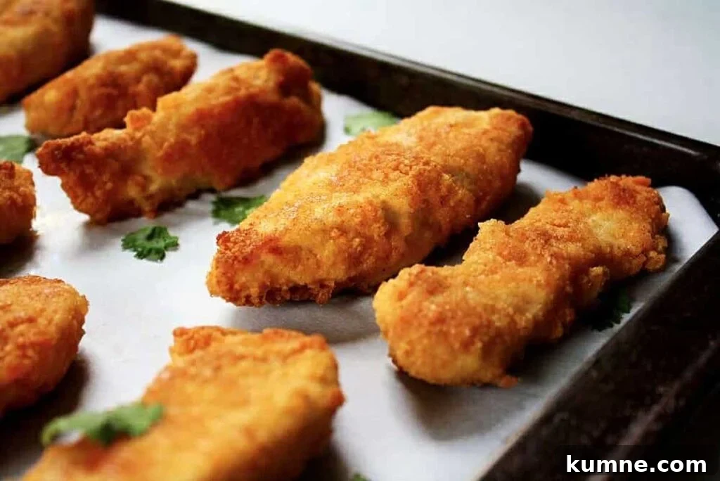 Chicken tenders on a pan.