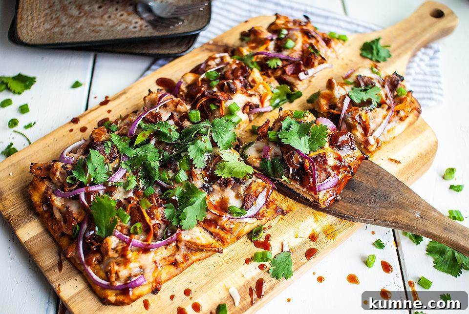 A flatbread pizza on a cutting board with a slice being removed.
