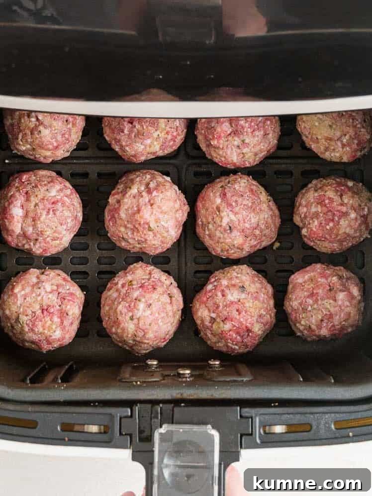 Crispy Air Fryer Italian-Style Meatballs Recipe 11 Uncooked meatballs in the air fryer.