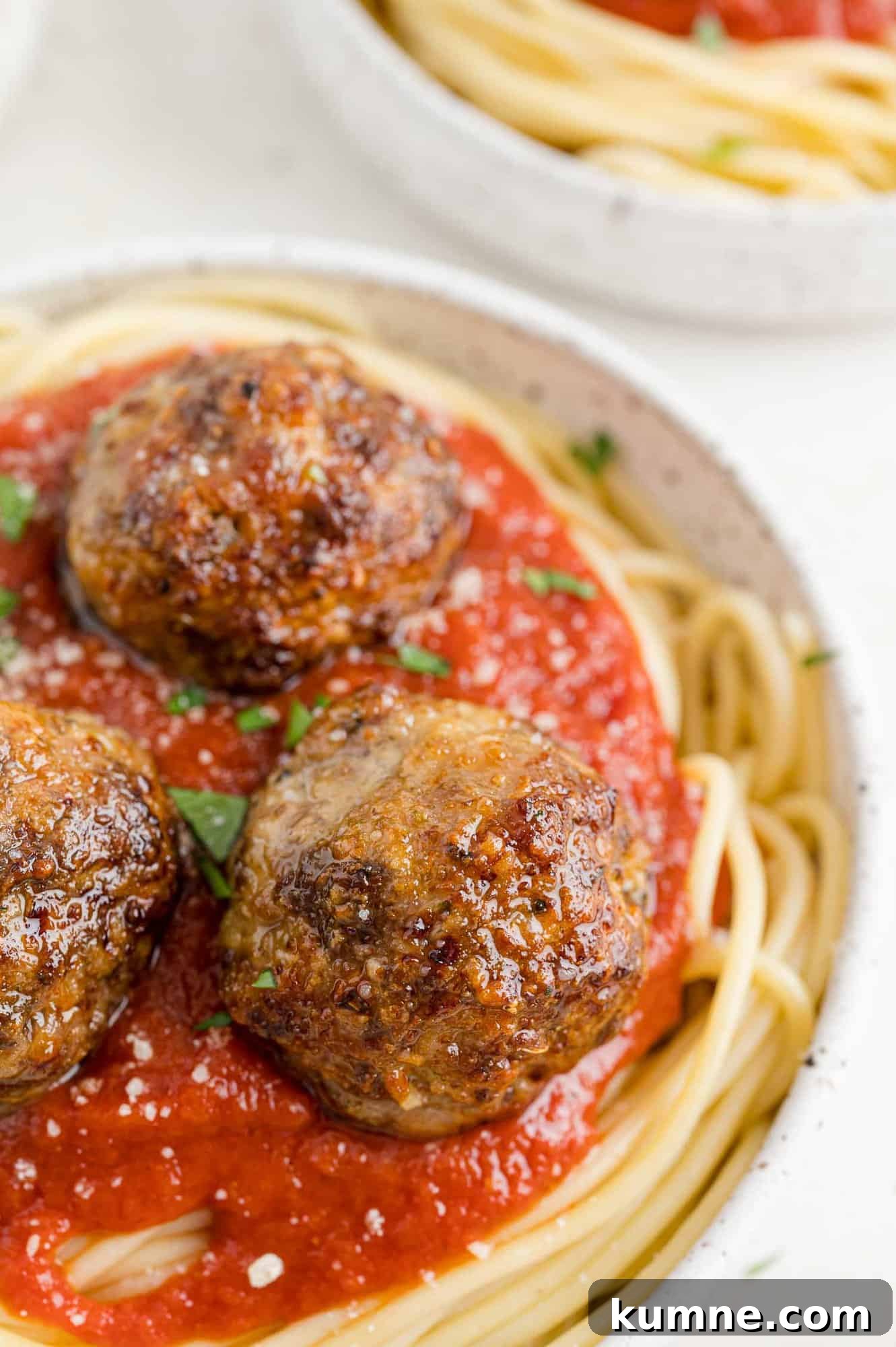 Crispy Air Fryer Italian-Style Meatballs Recipe 3 Meatballs atop spaghetti.