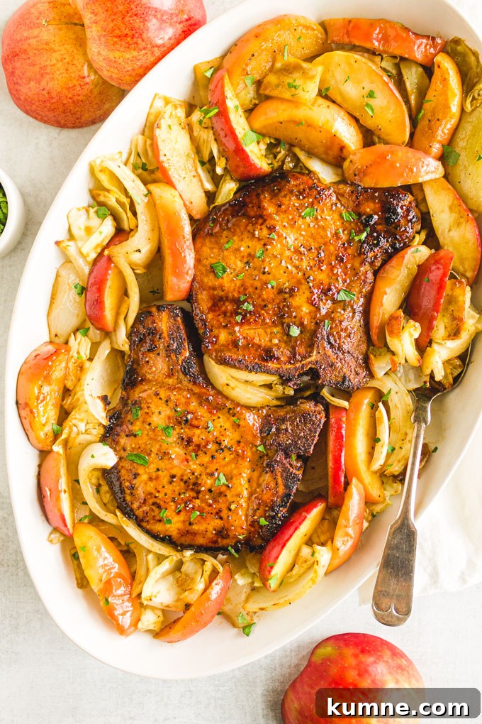 overhead of maple pork chops on a platter with roasted apples and cabbage