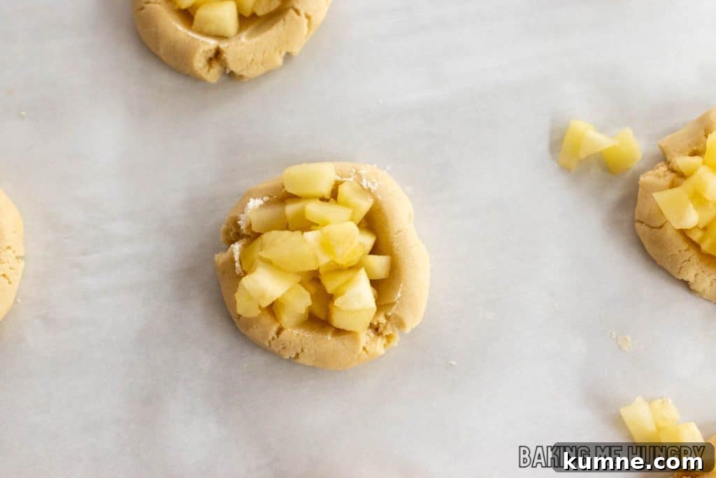 Apple Crumble Cookie Recipe — Soft Baked Fall Cookies, Step-by-Step 9 softened apples added to thumbprint
