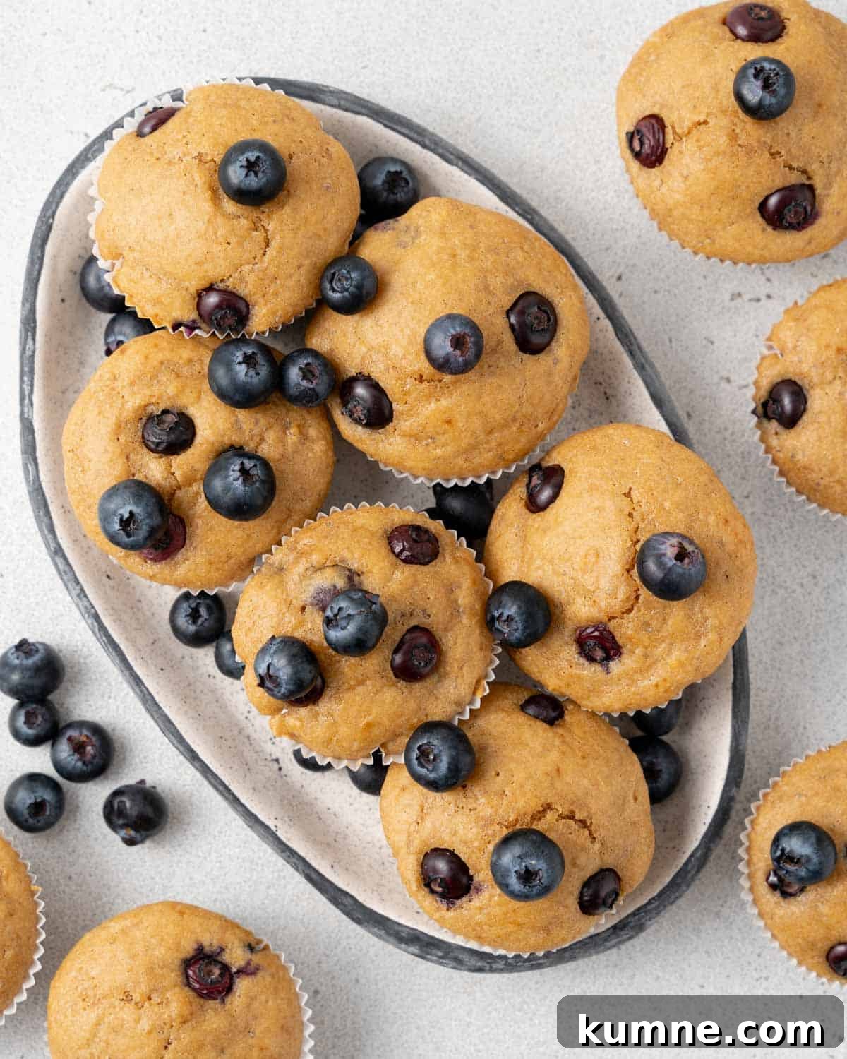 six blueberry muffins on a dish.