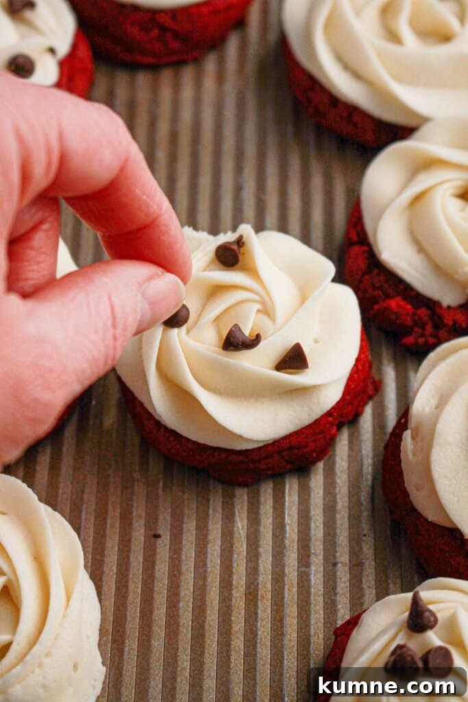 Chocolate chips being added to cookies.