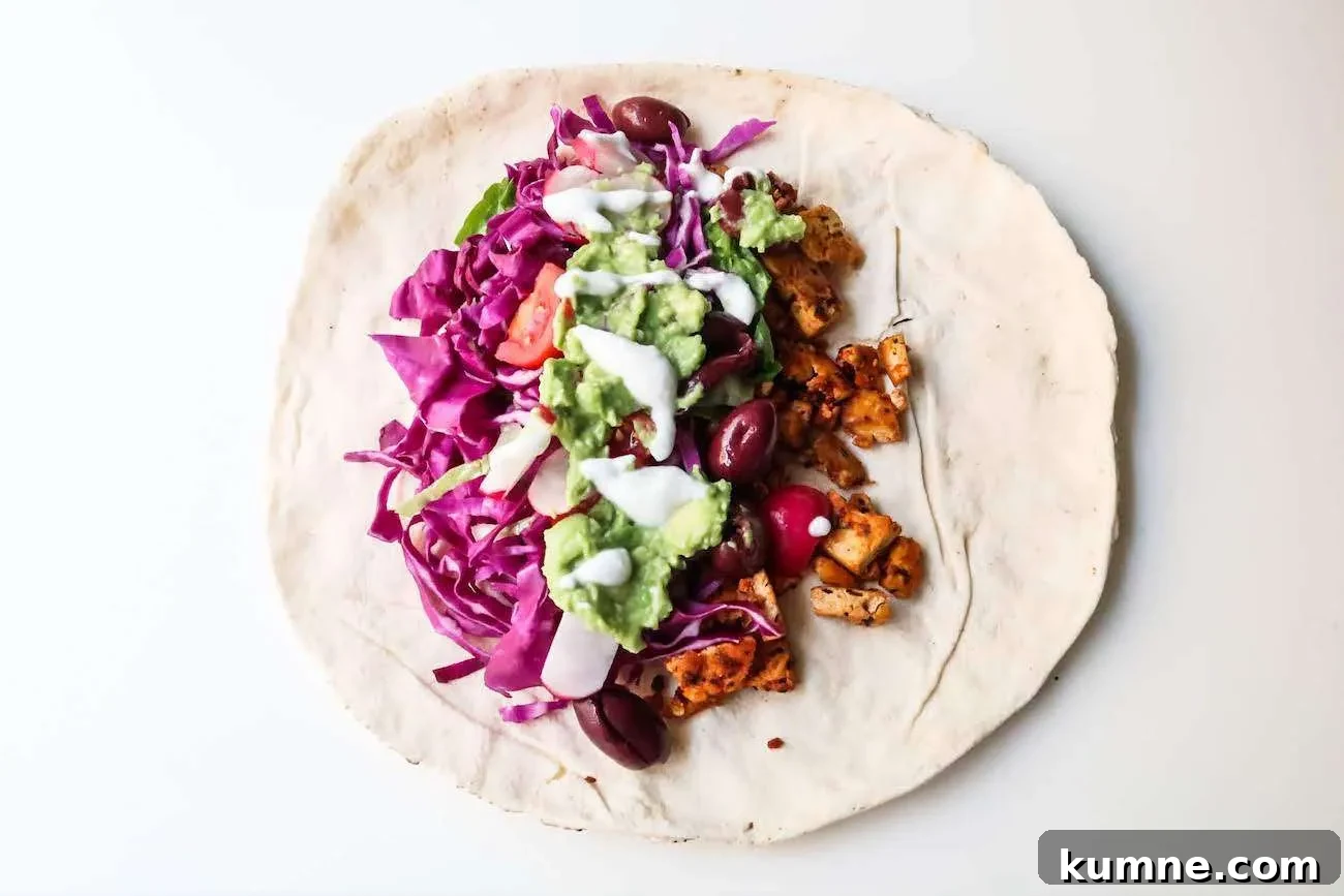 30-minute vegan tofu wraps recipe - amazing vegan dinner recipe, super delicious, healthy vegan meal that is high in protein and super satisfying. This meatless dinner is great for you even if you’re not on a plant-based diet. Filled with healthy vegetables, avocado, garlicky sauce and spicy tofu this tofu recipe has become a favorite in our family! This easy vegan dinner comes also with a simple meal prep option.