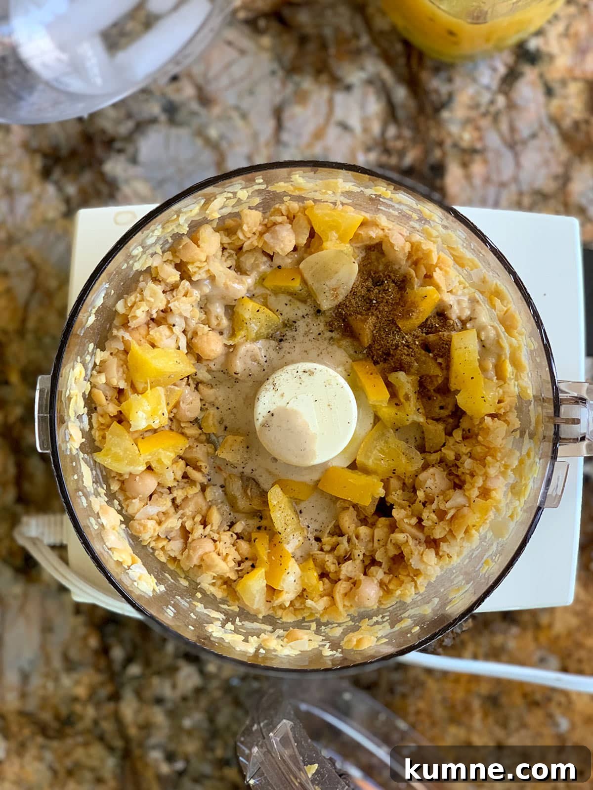 Add lemons and spices to chickpeas in processor.