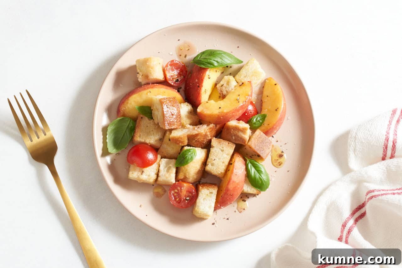 Peach panzanella served on a plate