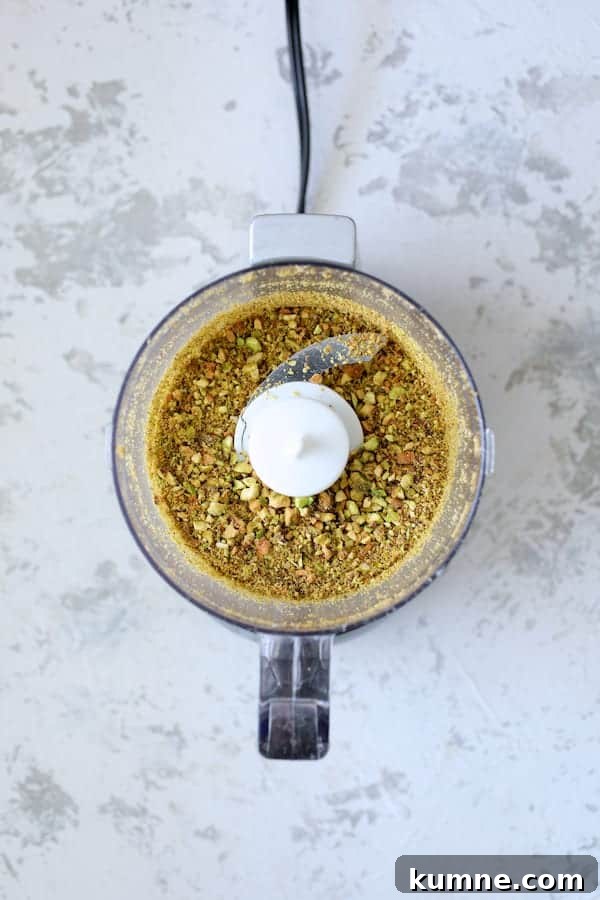 Photo of chopped pistachios in mini food processor.