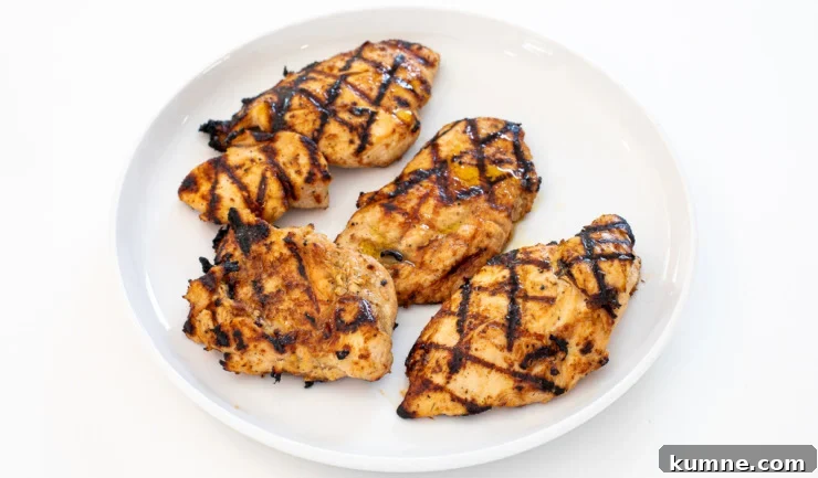 Sliced grilled chicken served with lemon