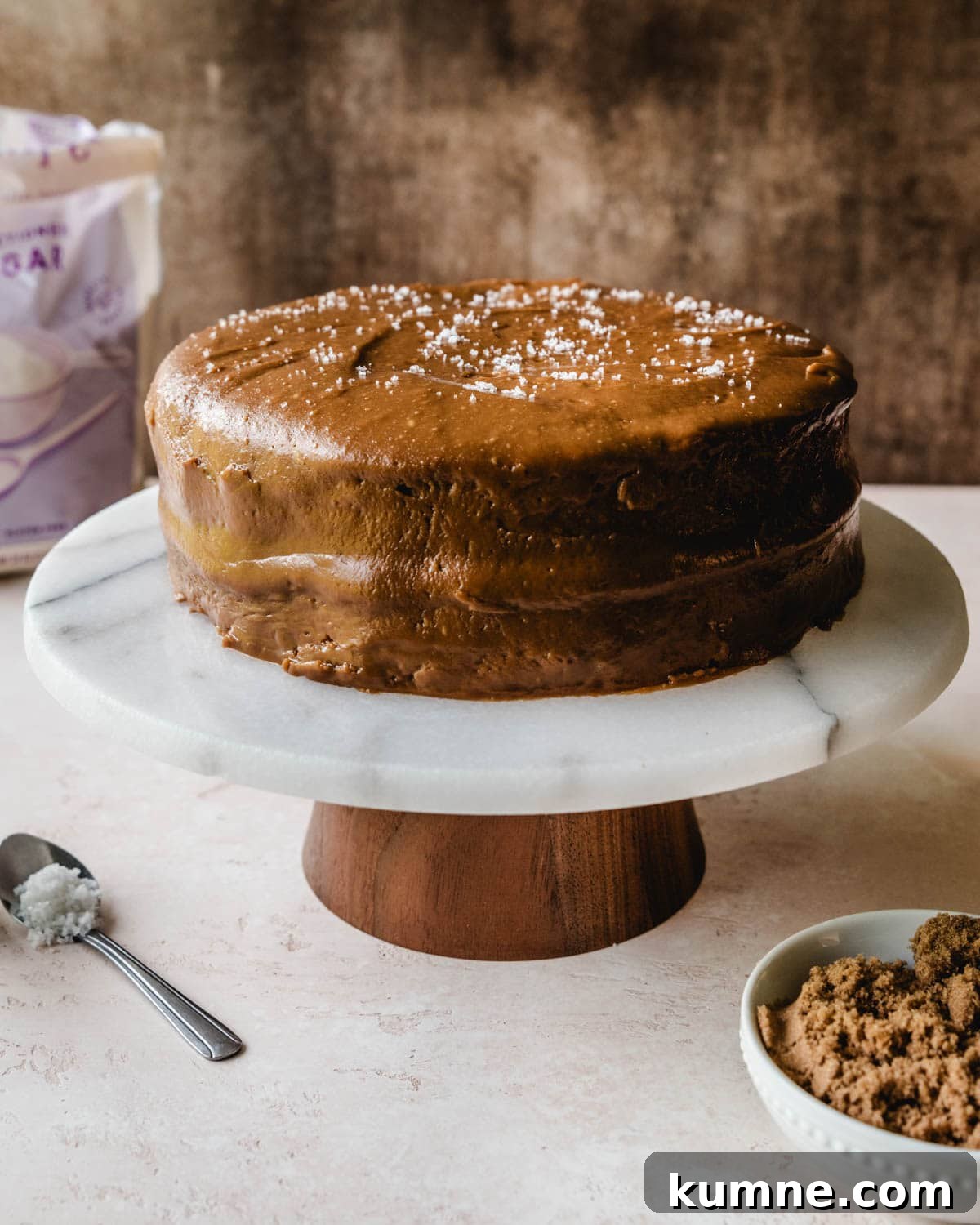 Fluffy salted caramel cake on a cake stand.