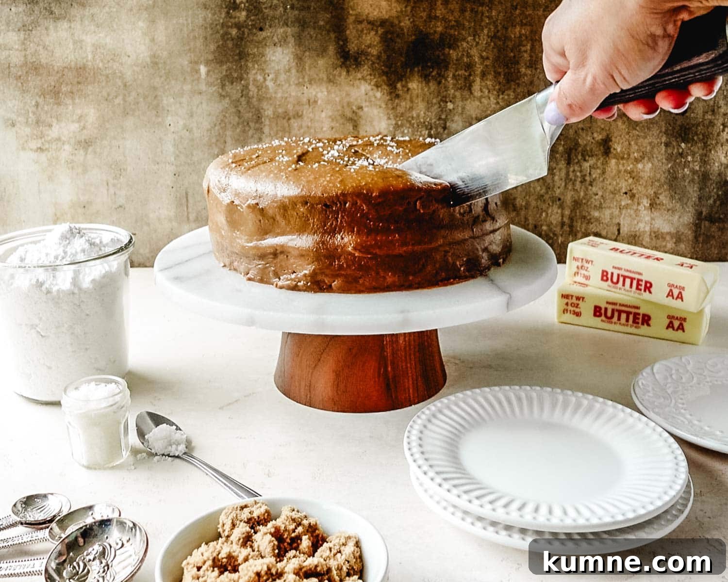 Slicing into a salted caramel cake.