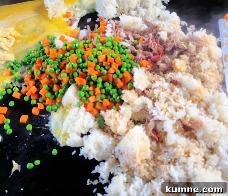 Shredded Pork Fried Rice cooking on blackstone griddle