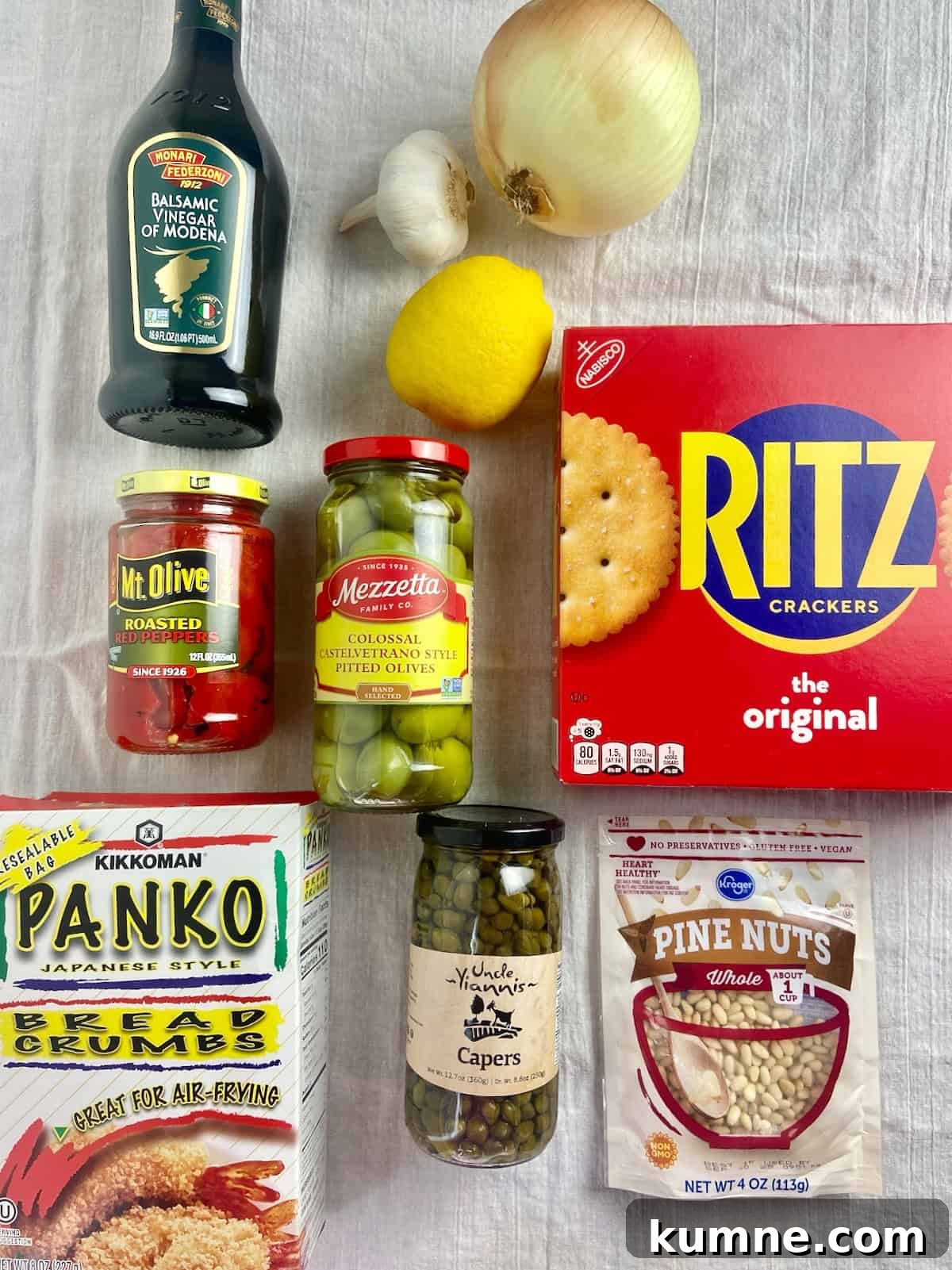 Sicilian baked cod ingredients on white table.