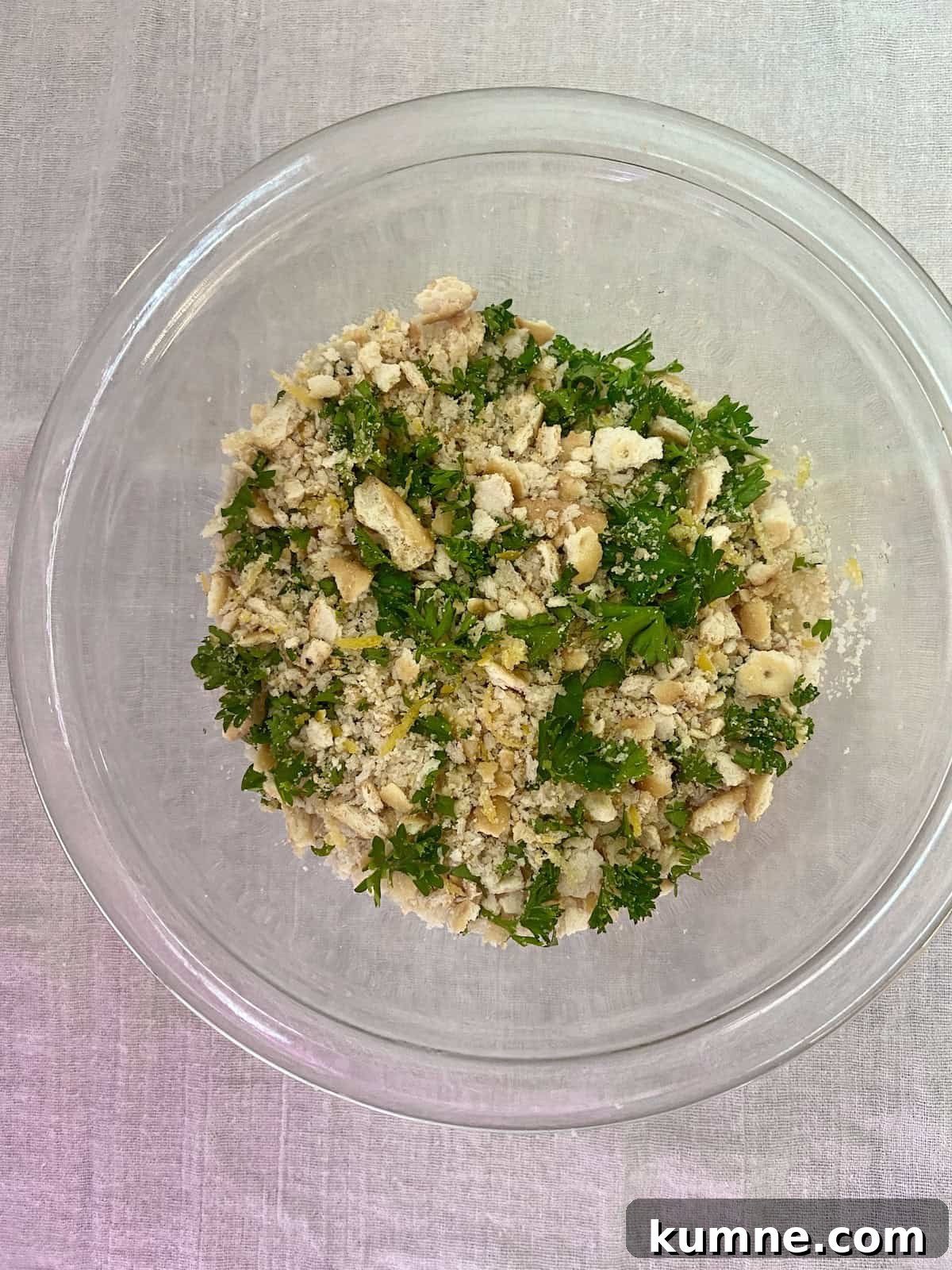 Breadcrumbs and parsley in mixing bowl.