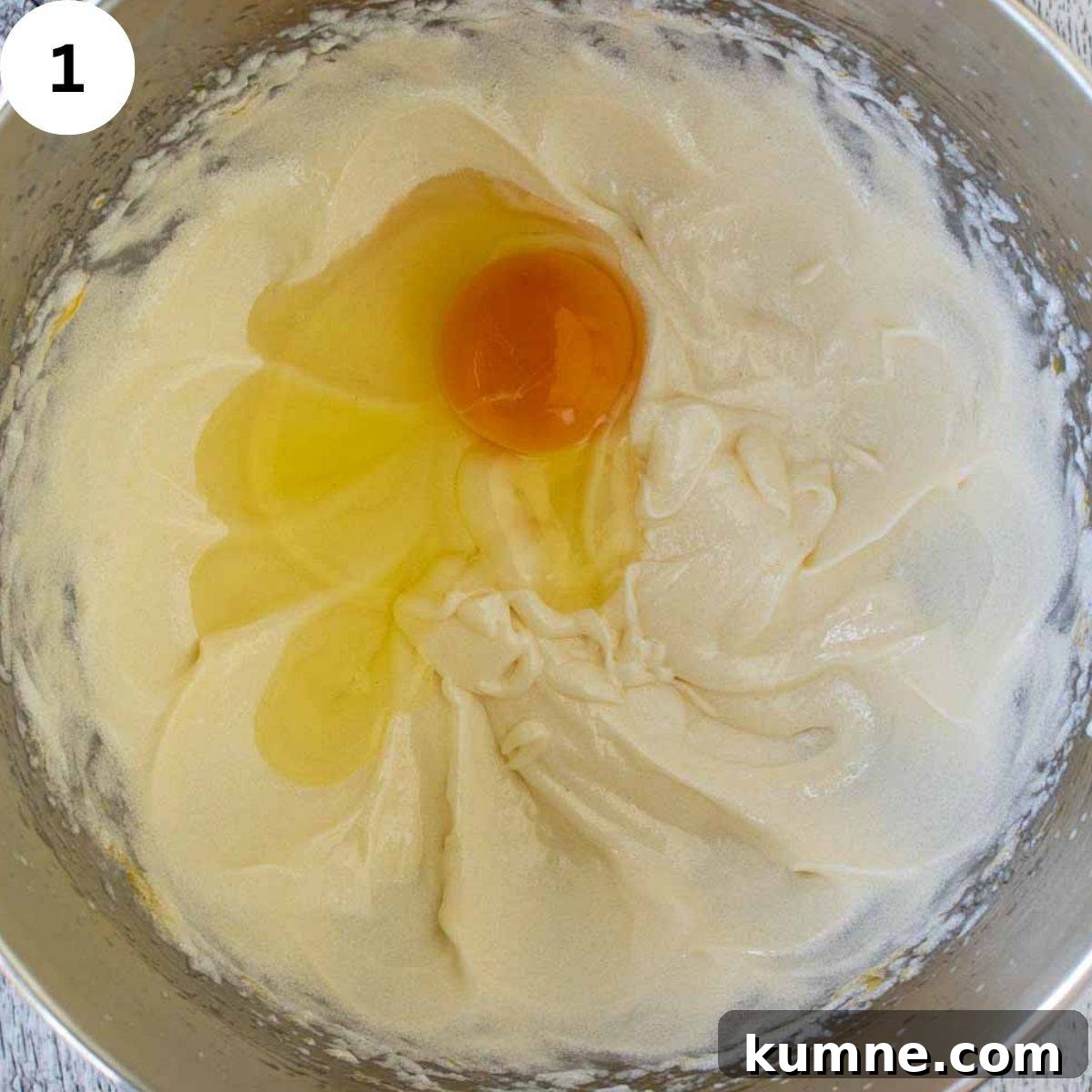 A egg cracked onto creamy butter mixture.