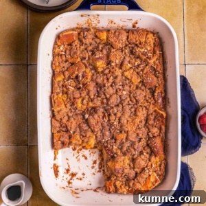 A baked French toast casserole with serving plates and fork.