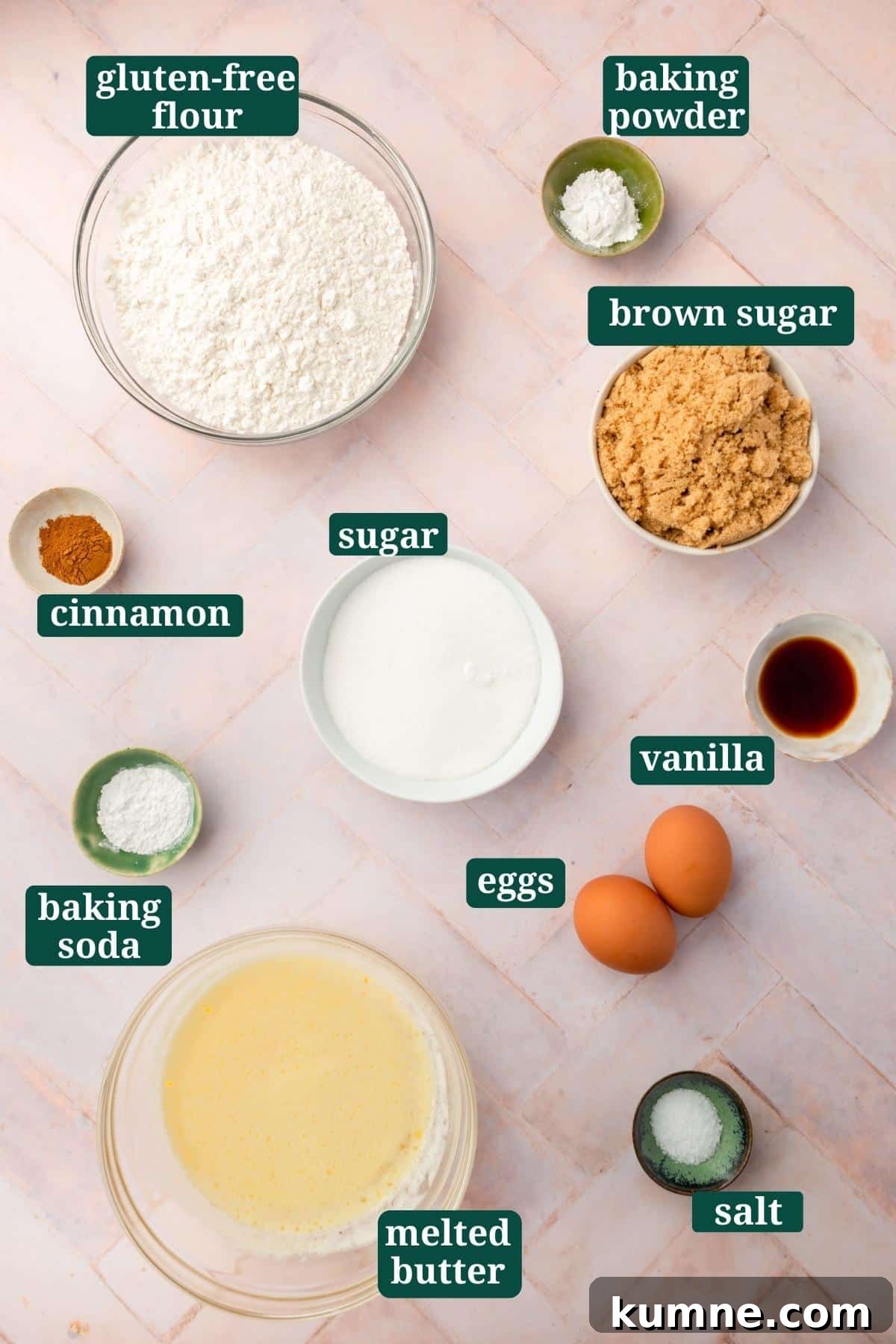 Small bowls of ingredients on a pink table to make gluten-free snickerdoodle bars, including gluten-free flour, baking powder, brown sugar, vanilla, sugar, cinnamon, baking soda, eggs, melted butter and salt with text overlays over each ingredient.