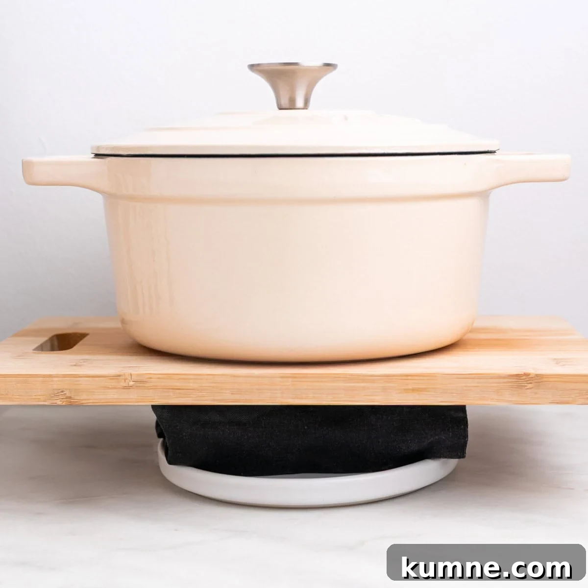 Tofu being pressed with a towel and weight